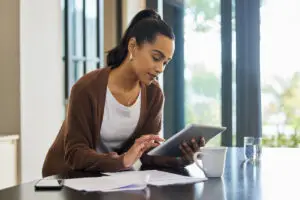 Person reviewing tax documents and checking IRS refund status on a laptop, symbolizing how to protect your tax refund from offsets