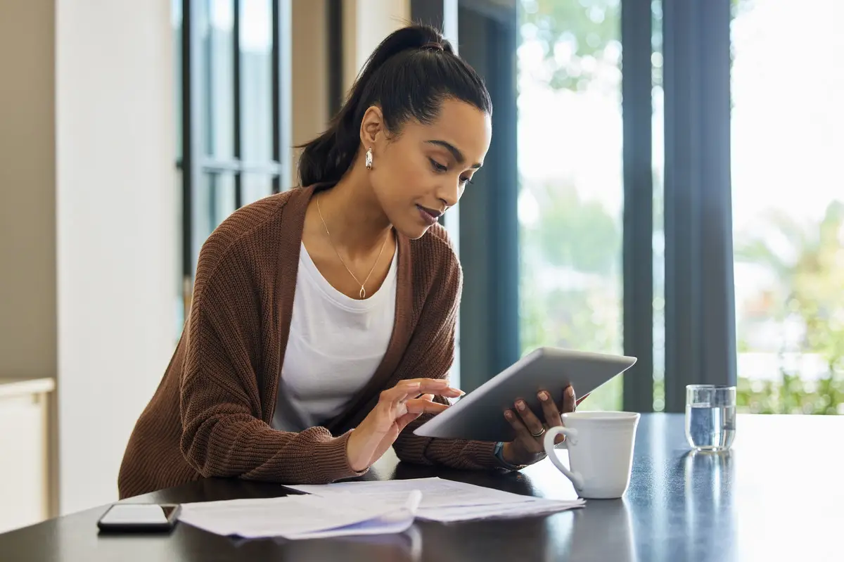 Person reviewing tax documents and checking IRS refund status on a laptop, symbolizing how to protect your tax refund from offsets